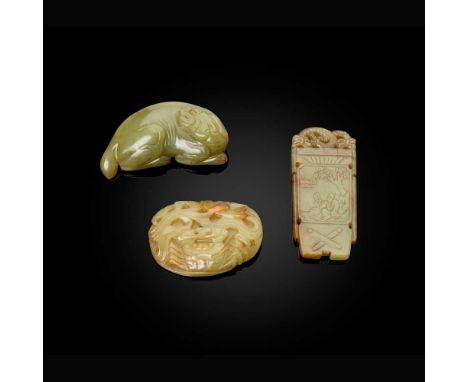 GROUP OF THREE YELLOW JADE CARVINGS QING DYNASTY, 19TH CENTURY   清 黃玉雕臥犬、荷塘蟹趣及古琴型玉牌（共三件） comprising: a reclining dog, 6.5cm w