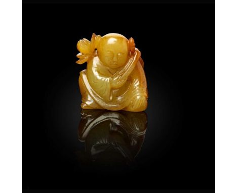 YELLOW JADE CARVING OF A BOY QING DYNASTY, 19TH CENTURY   清 黃玉雕童子持蓮把件 carved in round with a seated boy carrying a large lotu