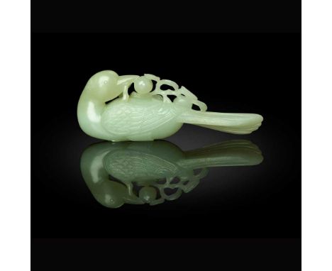 PALE CELADON JADE CARVING OF A MAGPIE WITH POMEGRANATES QING DYNASTY, 18TH CENTURY   清 青白玉雕鵲鳥銜石榴擺件 the magpie carved grasping