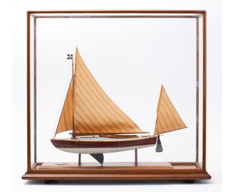A cased model of the canoe yawl 'Crayfish' 1898-1901: fully rigged over detailed deck and cockpit, the hull painted brown to 