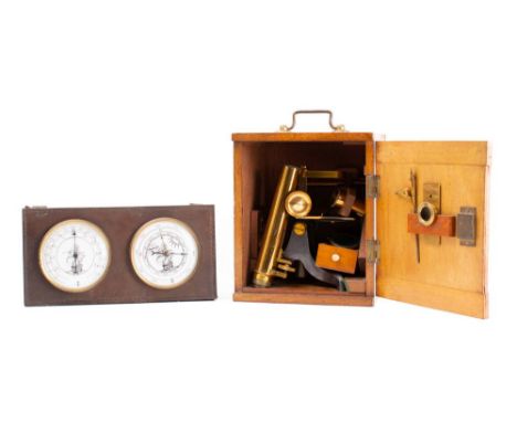 A lacquered brass student microscope: the monocular tube with coarse/fine adjust over a fixed stage with plano/concave mirror