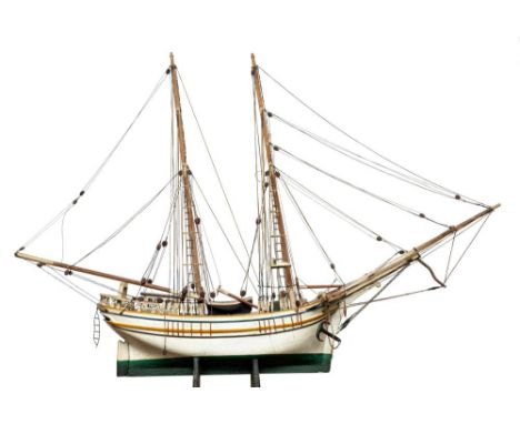 A scale model of a Baltic trader: running rigged over deck with wheelhouse, winch and fitting, white painted hull with green 