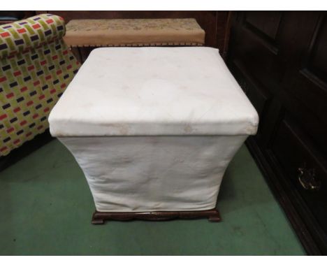 A Victorian rosewood box seat stool the hinged seat over a bracket foot and shaped base on ceramic castors