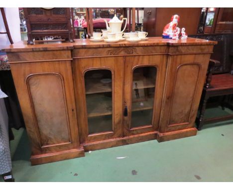 Circa 1840 a figured walnut breakfront bookcase the two central glazed central doors with height adjustable shelf interior fl