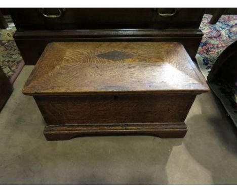 A Victorian oak trinket box with faceted lid, bracket feet 