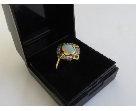 An Opal, emerald and zircon dress ring, gold plated shank stamped 925 