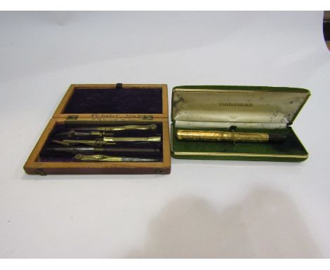 A Waterman's gold nibbed fountain pen with foliate relief design case, together with a vintage geometry set (2)