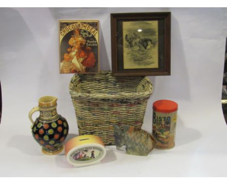 A basket containing a "Chocolat Ideal" advertising tile, Whittard "Percy the Park Keeper" ceramic money box, bygone Bisto tin