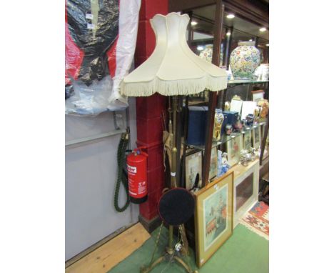 A brass standard lamp on scroll tripod base, flared form shade