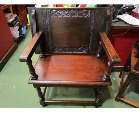 A circa 1890 carved acanthus leaf oak settle, the carved drop-down table top/backrest on turned supports and legs with rear c