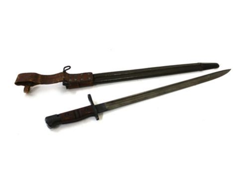 An American Remington 1917 pattern bayonet and a metal leather mounted scabbard, the scabbard bearing numerous dates and stam