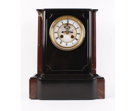 A Victorian mantle clock striking on a bell, the enamelled face with Roman numerals and a visible escapement within a rouge m