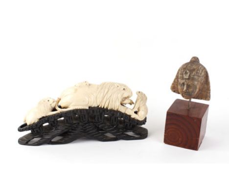 A 19th century carved tusk modelled as a pride of lions on an ebonised base, l. 26.5 cm, together with an Egyptian carving mo