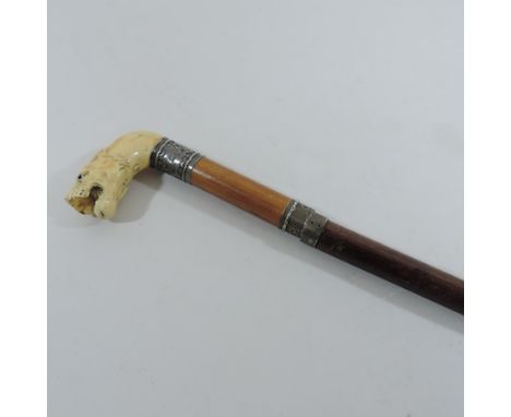 A late 19th century Indian swordstick, with a shaped steel blade and carved handle in the form of a tiger's head, 90cm long