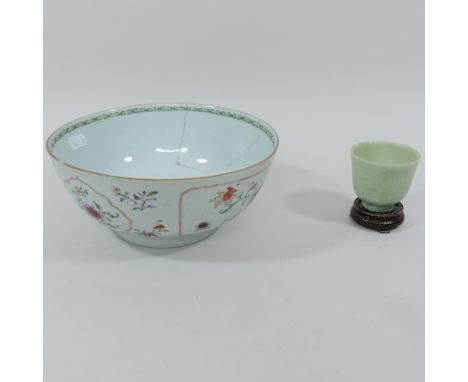 An 18th century Chinese porcelain bowl, together with a Chinese jade coloured hardstone bowl, on stand