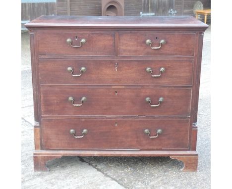 A George III mahogany chest, containing two short over three long graduated drawers, between canted angles, on bracket feet, 