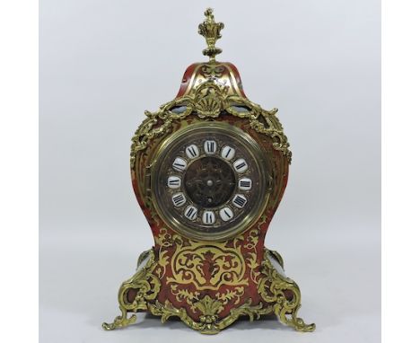An early 20th century French boulle style cut brass and tortoiseshell mantle clock, with a porcelain and gilt metal dial, and