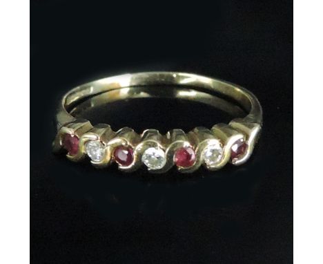 A 9 carat gold diamond and ruby seven stone eternity ring