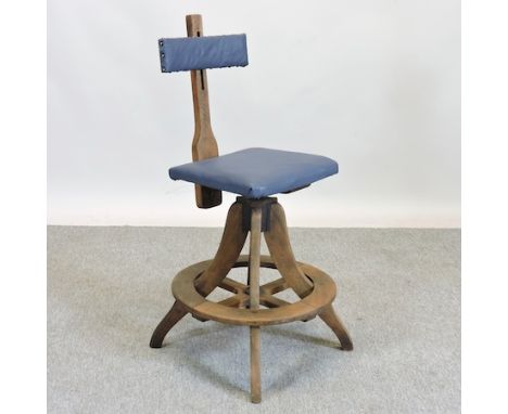 An early 20th century oak and blue upholstered draughtsman's chair, stamped R. Tyzack G V R 1943, on a circular base, 50cm di