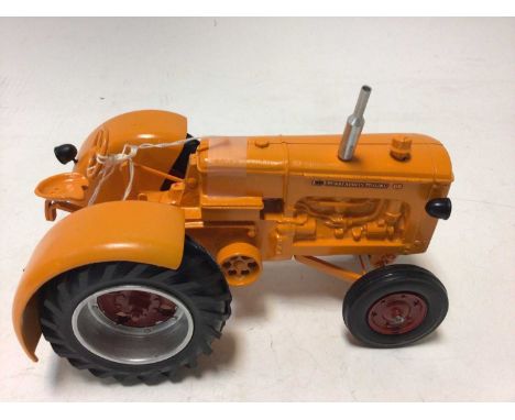 Arcade cast iron tractor and driver grey &amp; red livery plus a Minneapolis Moline cast metal model of a tractor orange &amp