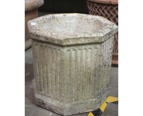 Three chimney pots, 90cm high, (damages) and an octagonal reconstituted stone planter, 42cm high, 45cm wide, (4). 