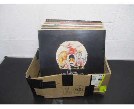 A collection of 12" vinyl records including Queen, Rod Stewart, Jethro Tull, Wings, Santana, Phil Collins, Fleetwood Mac, Mic