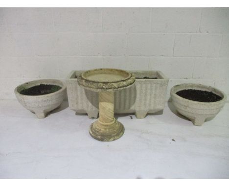 A conglomerate stone trough, a pair of matching planters and a bird bath