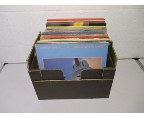 A collection of 12" vinyl records including Dire Straits, John Lennon, Styx, Carly Simon, Phil Collins, Mike Oldfield, Elvis 