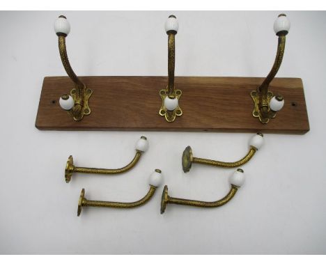 A collection of Victorian brass and ceramic coat hooks 