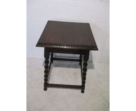 A carved oak centre table with bobbin turned legs