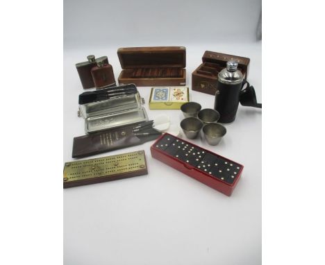 An assortment of vintage games including dominoes, playing cards, crib board, two sets of darts, three hip flasks. 