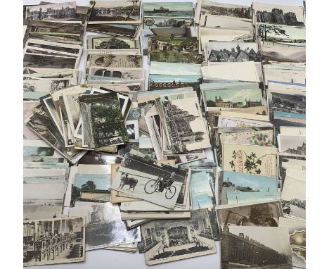 A collection of vintage postcards and greetings cards many showing seaside scenes