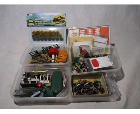 A collection of model railway scenery and figures including telegraph poles, people, animals,  hay bales, stations signs/noti