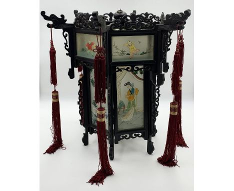 A Japanese hanging hexagonal lantern , each side with a glass panel painted with a traditional scene  a second glass panel ab