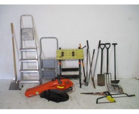 A collection of various tools including spades, garden fork, rake, clippers, step-ladder, saws, workmate, Black &amp; Decker 