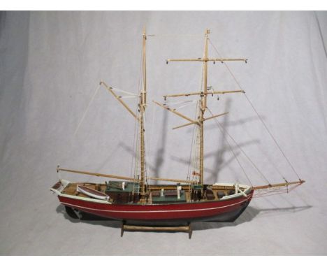 A wooden model of sailing ship on stand