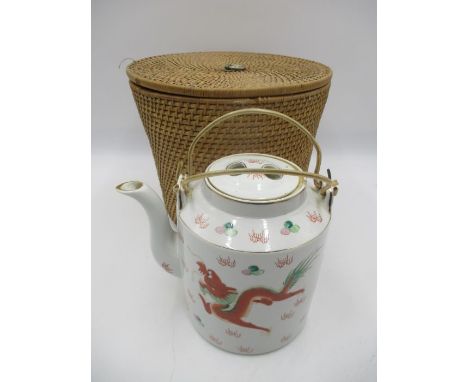 A Chinese teapot in wicker carry case