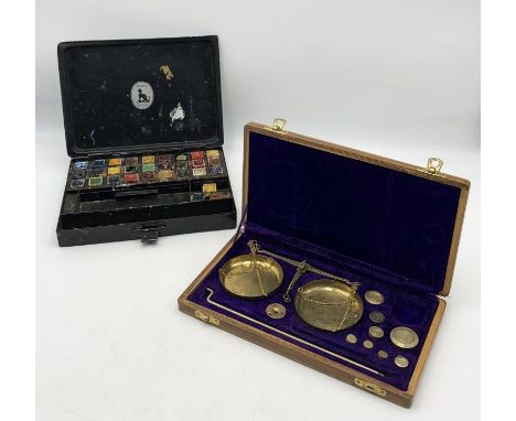 A vintage reeves artist paint box with paints along with a cased set of brass scales - one weight missing