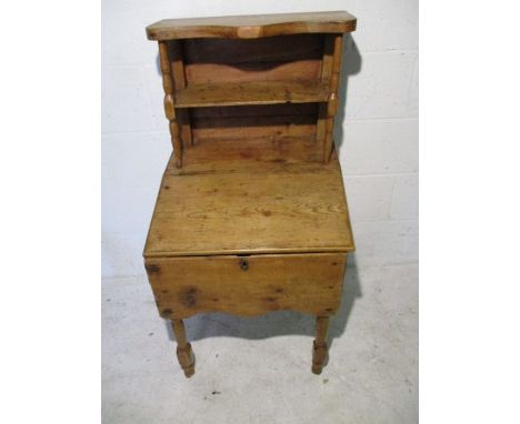 A vintage pine desk with two shelves above