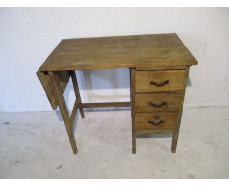 A vintage oak desk with three drawers