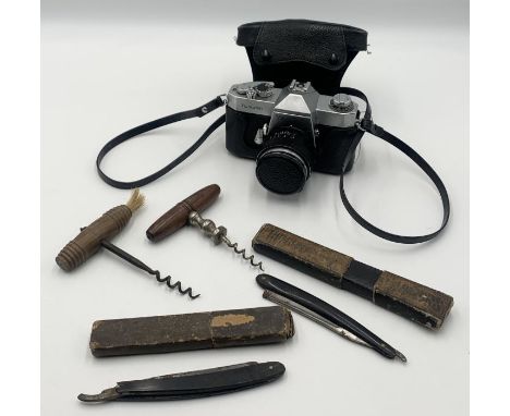 Two cut throat razors along with two corkscrews and a vintage Yashica camera