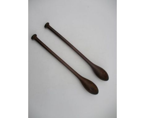 A pair of vintage wooden exercise clubs