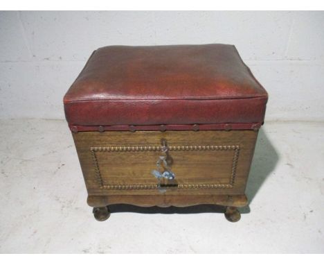 A vintage oak foot stool with secret compartment