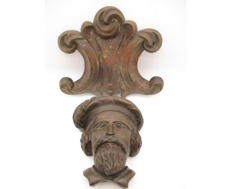 An antique carved wooden head of a Scot wearing a feathered bonnet with feather along with a carved  panel