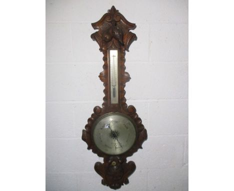 A Victorian Angelinetta &amp; Bregazzi, London heavily carved oak barometer decorated with fruit and the Union flag