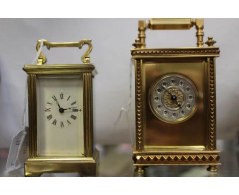 An early 20th Century French brass carriage clock of small size, circular silver dial with Arabic numerals, back stamped R an
