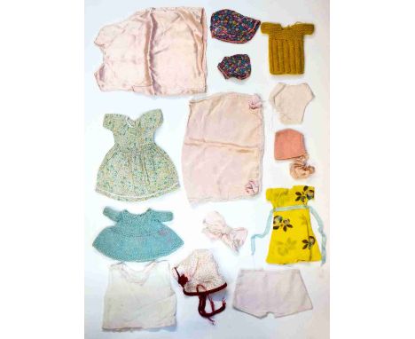 A good collection of dolls clothes to include dresses, knickers, bonnets, wool item and a satin under slip and nightdress cas