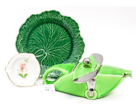 A 1930s ceramic teapot in the form of an aeroplane, green with silver trim, a Wedgwood Cabbage plate and Shelley ash tray (3)