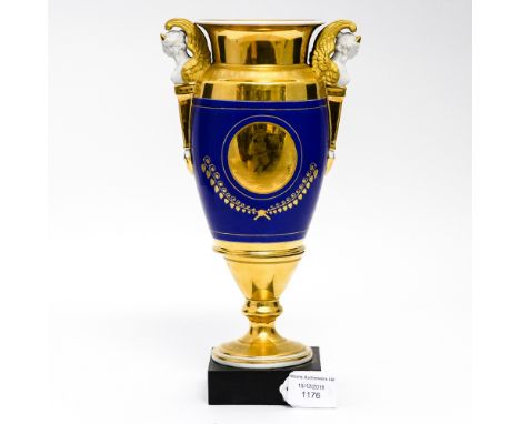 A Berlin type twin handled vase, Empire style, heavily gilded with a polychrome scene of a woman with child and harp, on blac