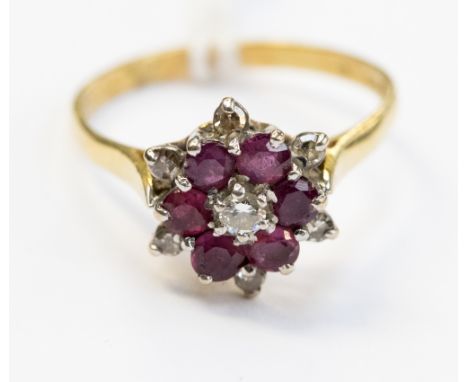 An 18 carat gold ruby and diamond cluster ring, size R, gross weight approximately 3.9 grams